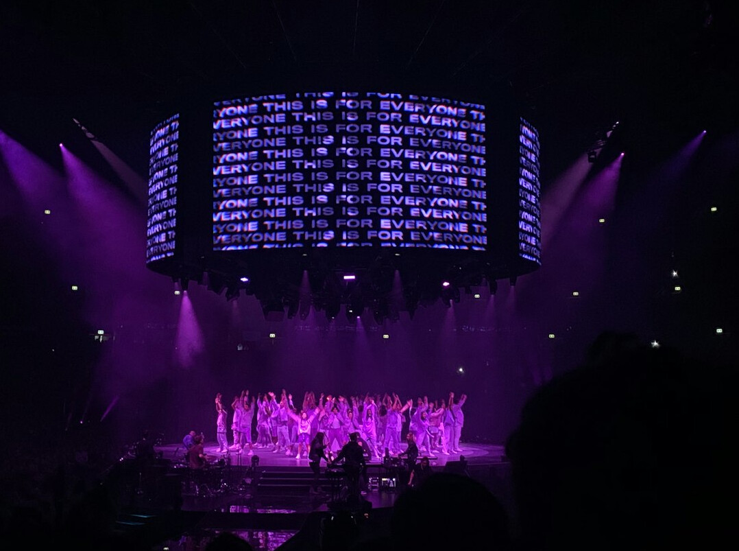 Large stage with LED screens and dramatic lighting