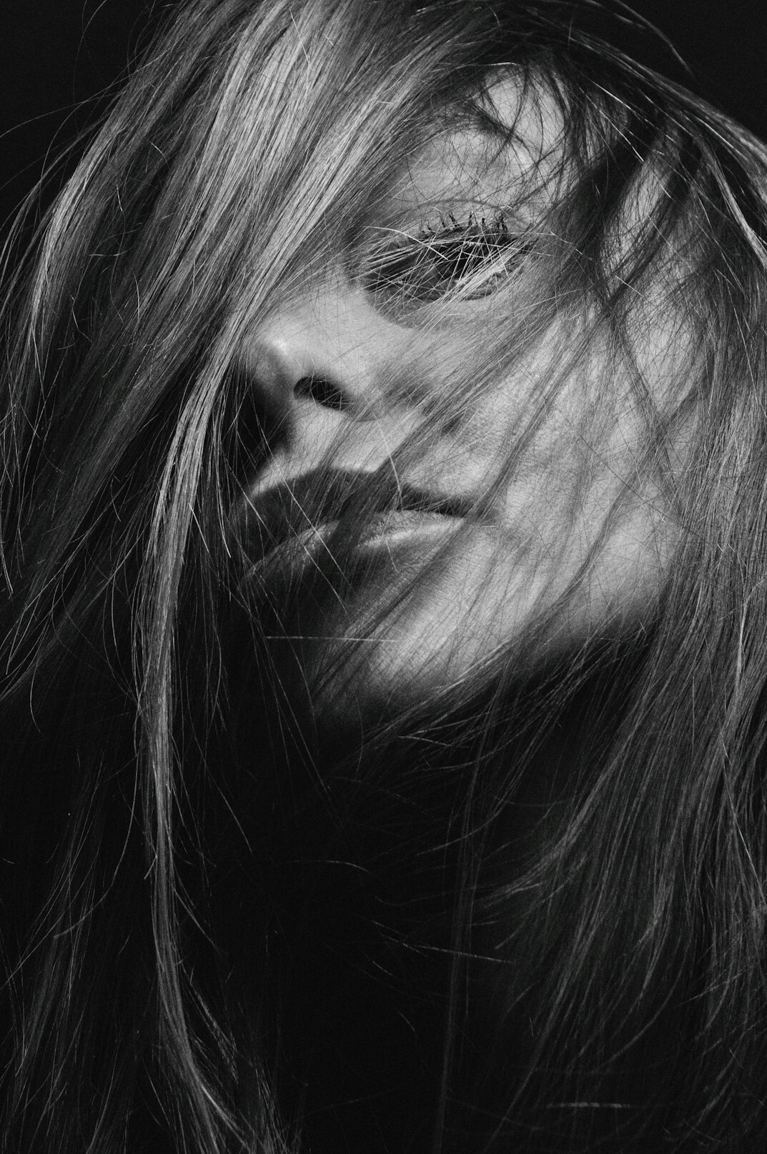Portrait of a woman with long hair smiling