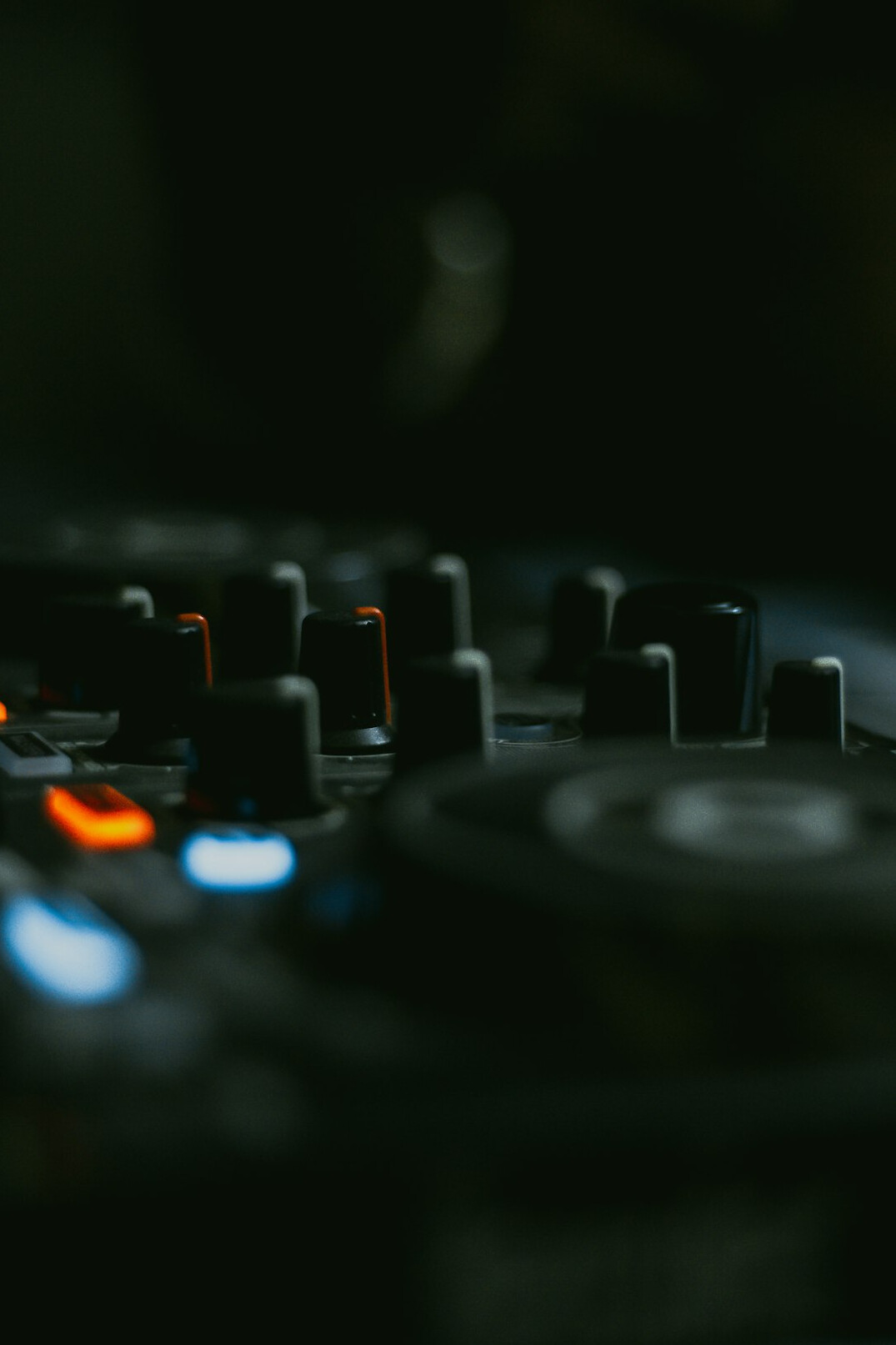 Audio mixing console with many faders and buttons
