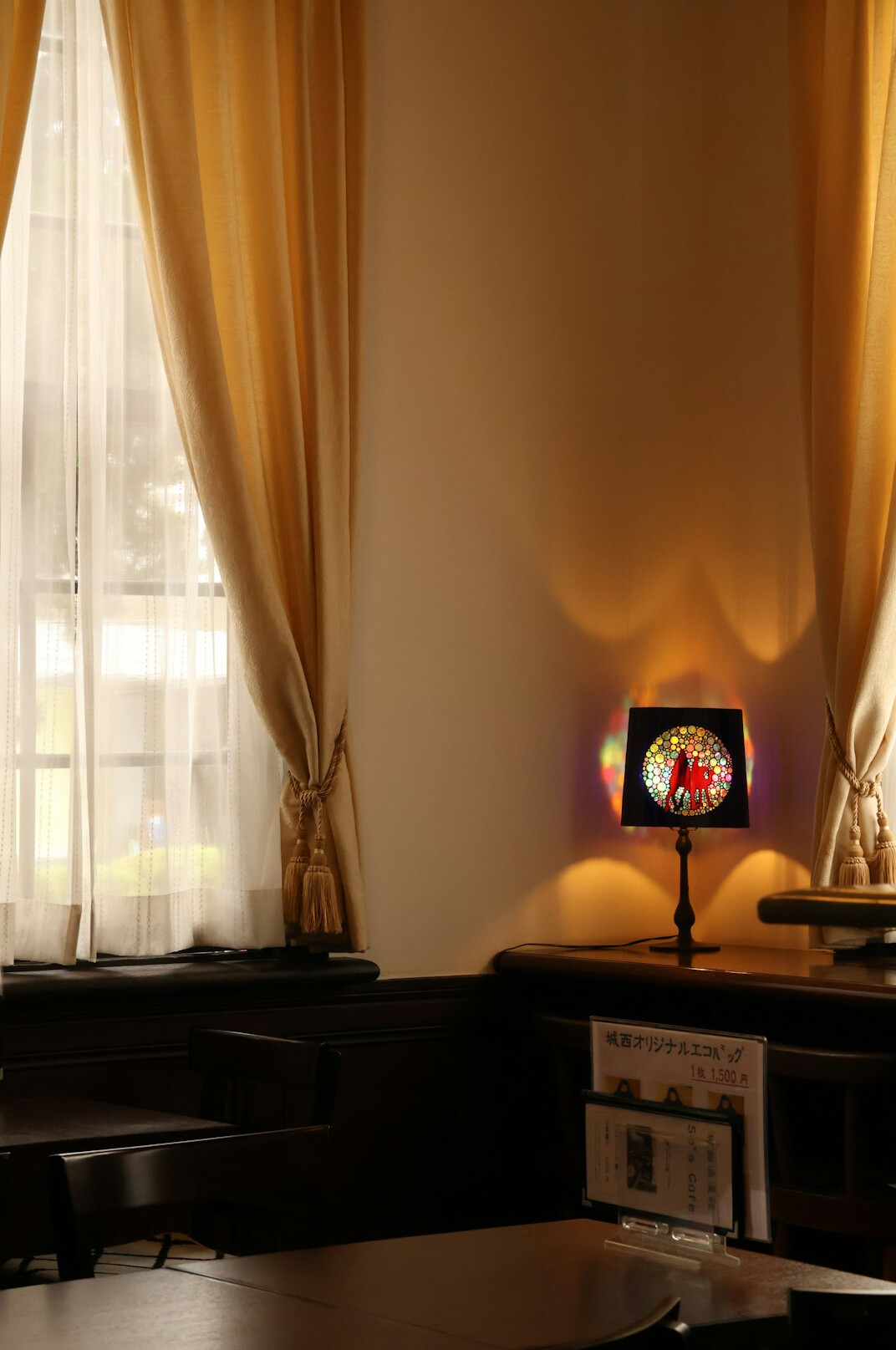 Open books and reading lamp on a desk